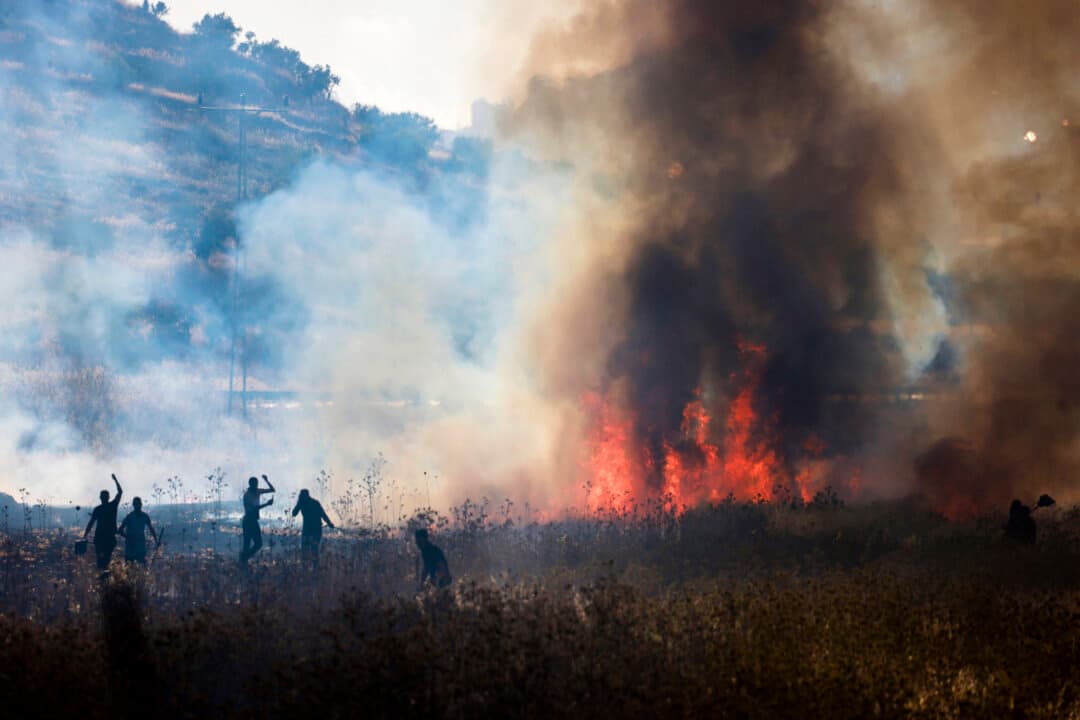 Palestinians attempt to extinguish a fire allegedly set by Israeli settlers on wheat fields in the village of Salem, east of Nablus, in the West Bank, on July 3, 2026. (Jaafar Ashtiyeh/AFP via Getty Images)