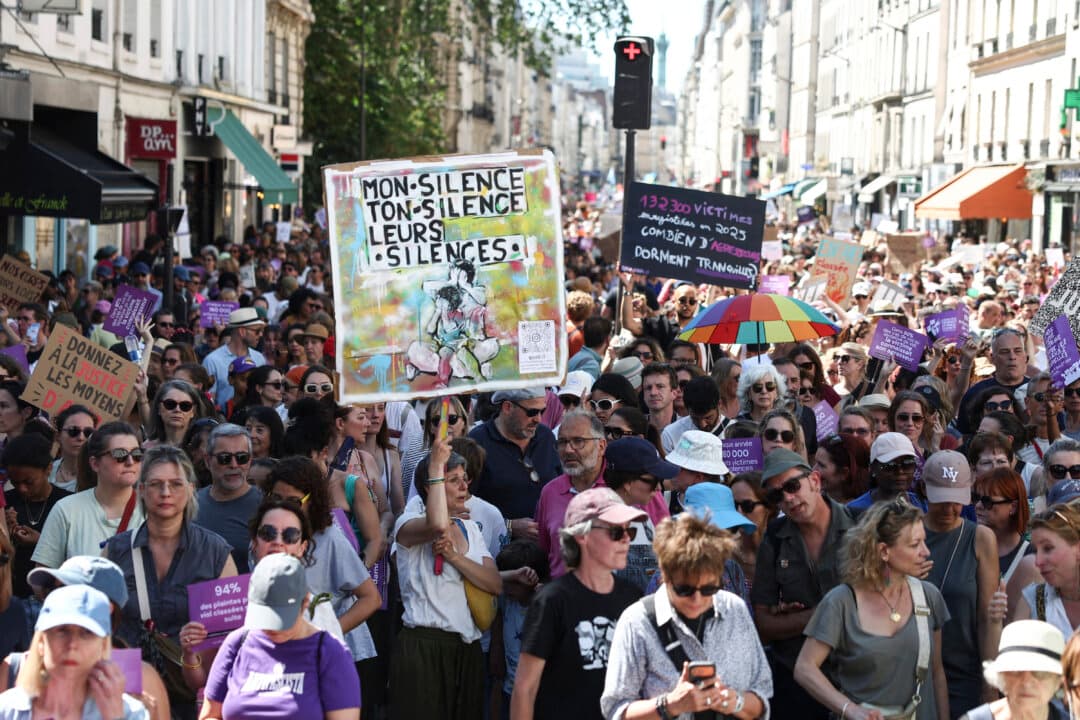 Demonstrators hold placards reading “my silence, your silence, their silences” (L) and “132300 victims registered in 2025, how many aggressors sleep tight?” (R) during a rally against sexual violence against women and children called by the Women's Foundation in Paris on July 4, 2026. (Romain Perrocheau/AFP via Getty Images)