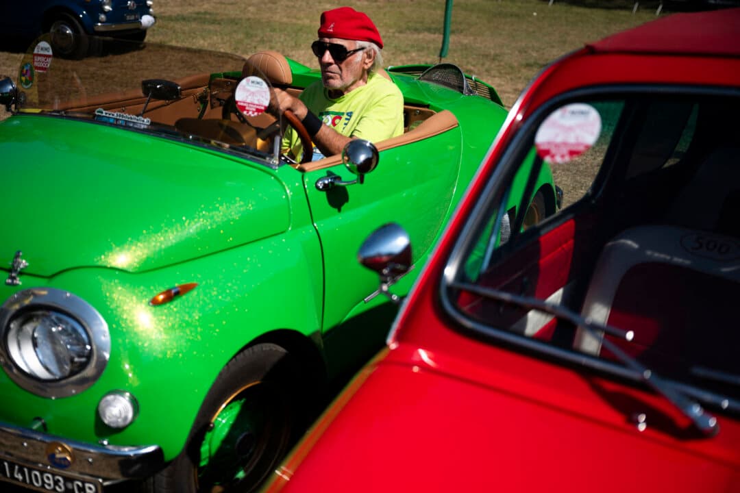 A Fiat 500 enthusiast drives a Fiat 500 custom model as he takes part in the 43th International Rally of Fiat 500 Club Italia, in Garlenda, Italy, on July 4, 2026. (Marco Bertorello/AFP via Getty Images)
