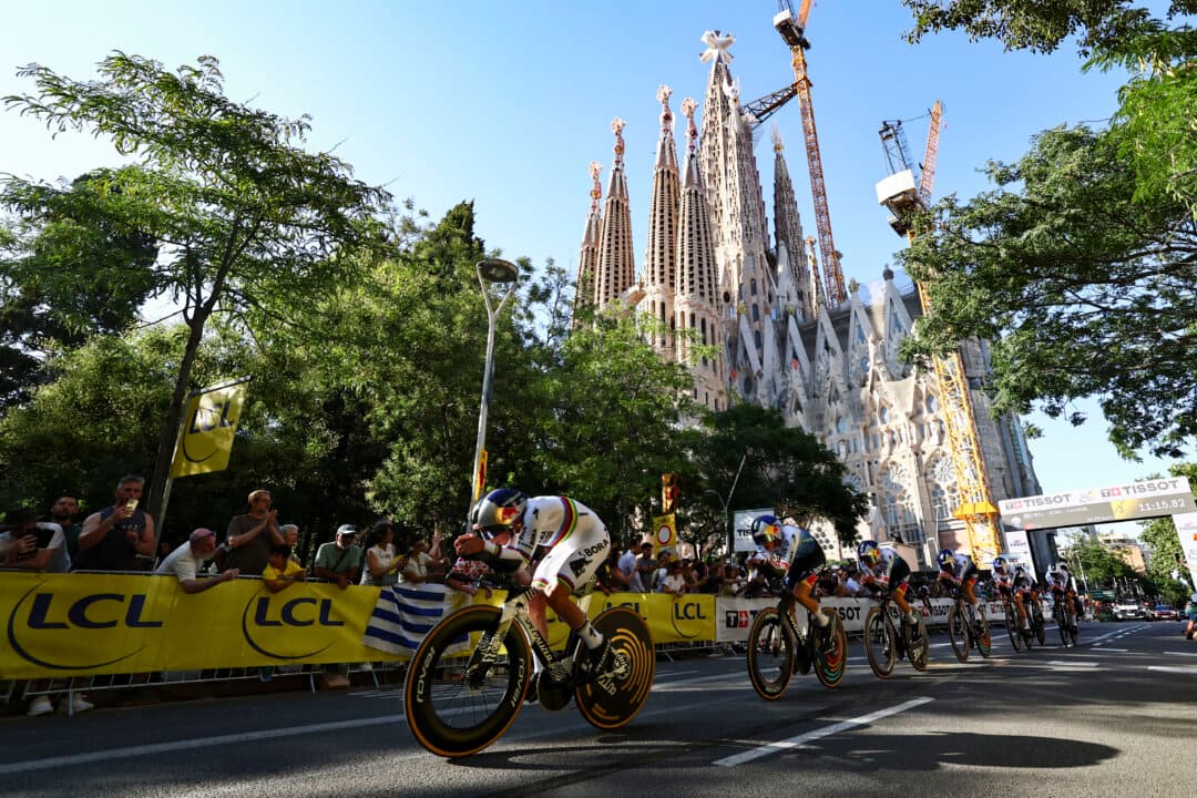 Belgian rider Remco Evenepoel (L) leads teammates as they cycle past the Sagrada Familia Basilica, during the 1st stage of the 113th edition of the Tour de France cycling race, a 19.6 kilometer team time trial stage in and around Barcelona, Spain, on July 4, 2026. (Anne-Christine PouJoulat/AFP via Getty Images)