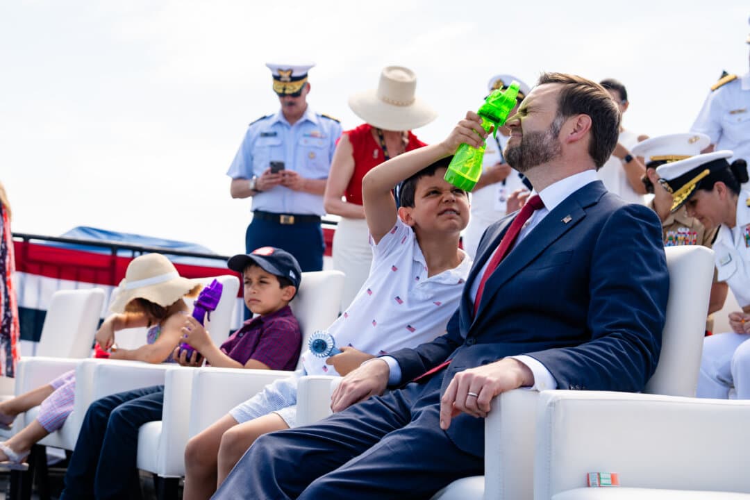 Ewan Blaine Vance cools off his father Vice President JD Vance aboard the USS Kearsarge at the International Naval Review 250 in New York City on July 4, 2026. (Samira Bouaou/The Epoch Times)