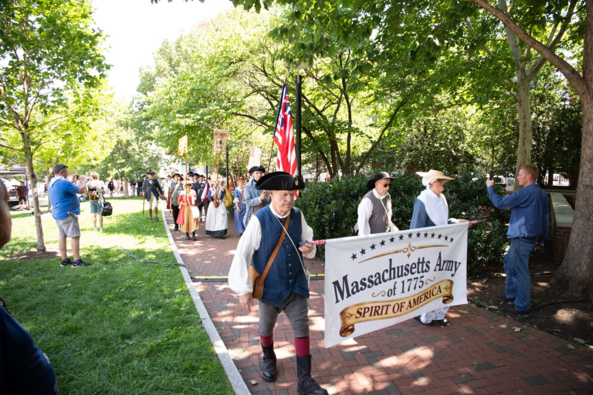 Despite temperatures approaching 100 degrees, thousands of performers and visitors gather at Philadelphia Independence Mall on July 3, 2026, to celebrate America's 250th anniversary. (Larry Dye/The Epoch Times)