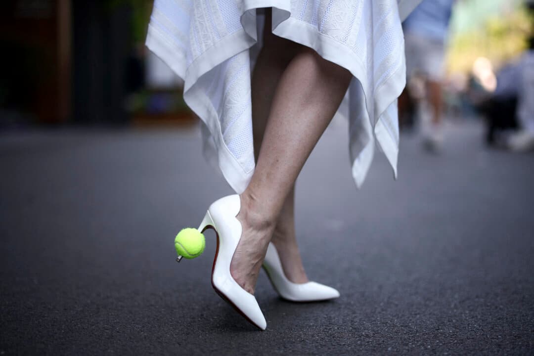 A woman wears tennis balls on her heels on the tenth day of the 2026 Wimbledon Championships at The All England Lawn Tennis and Croquet Club in Wimbledon, London, on July 8, 2026. (Henry Nicholls/AFP via Getty Images)