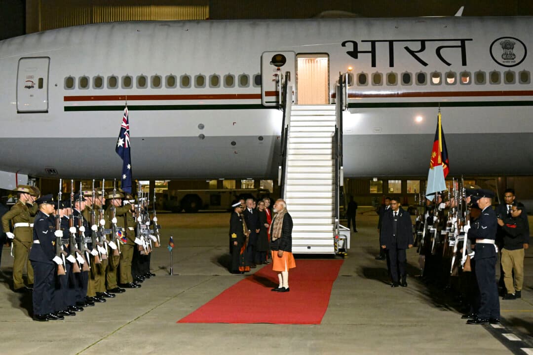 Indian Prime Minister Narendra Modi walks past members of the Australian armed forces upon his arrival at Melbourne International Airport in Melbourne on July 8, 2026, at the start of an official visit to Australia. (William West/AFP via Getty Images)