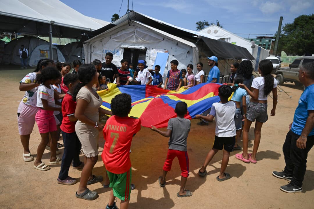 Children play at a temporary shelter site in the Cesar Nieves baseball stadium in La Guaira state, Venezuela, on July 8, 2026, following powerful earthquakes that struck the region. (Raul Arboleda/AFP via Getty Images)