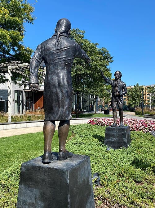 A dramatic artistic rendering of the moment shots were fired on the cliffs of Weehawken, N.J., resulting in the mortal wounding of Alexander Hamilton. (Rich Romano/<a href="https://commons.wikimedia.org/wiki/File:Hamilton-Burr_Duel_Monument.jpg">CC BY-SA 4.0</a>)