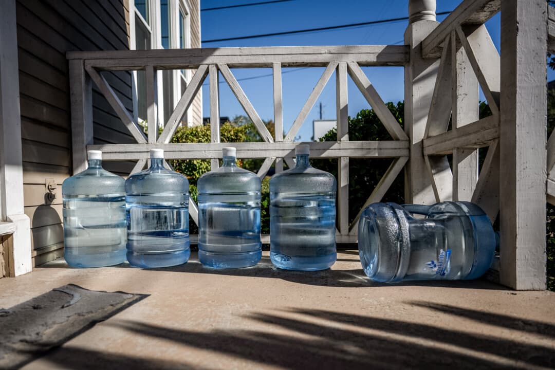 Filled water jugs are seen on a porch after a boil water notice in Houston, in this file photo. The city of Trinidad, Texas, issued a boil water notice on April 21, validating concerns about the safety of the city's water.(Brandon Bell/Getty Images)