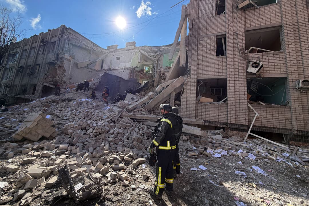 Ukrainian rescuers clear debris at the site of a Russian airstrike in Zaporizhzhia, Ukraine, on July 10, 2026. (Darya Nazarova/AFP via Getty Images)