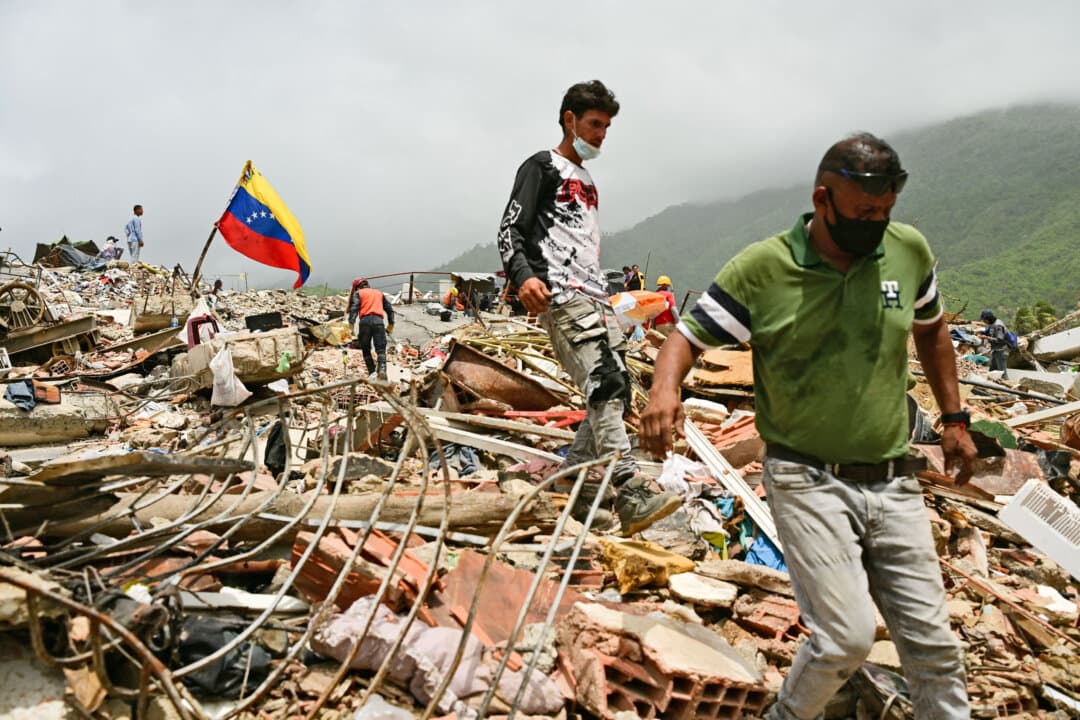 Relatives of missing people search for the bodies of loved ones at the site of collapsed buildings following the twin earthquakes of June 24 in Caraballeda, La Guaira state, Venezuela, on July 10, 2026. The disaster has claimed at least 3,889 lives, with nearly 17,000 people injured and almost 18,000 left homeless, according to official reports. (Martin Bernetti/AFP via Getty Images)