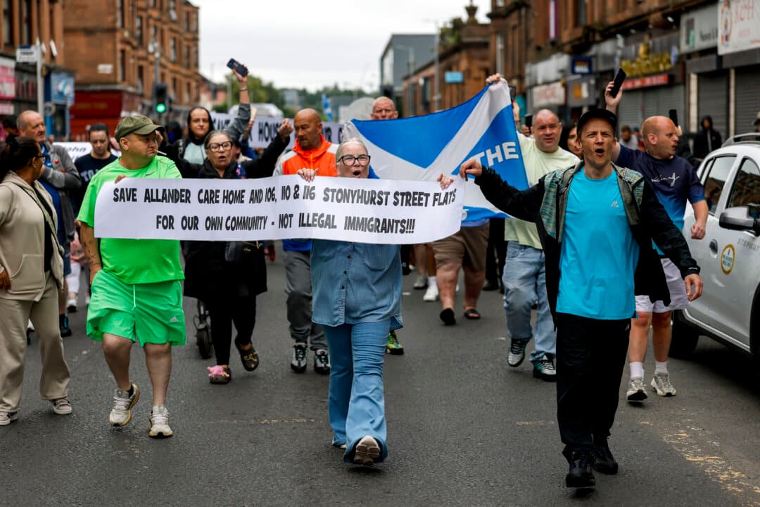 Members of the local community take part in an anti-migrant protest in Glasgow, Scotland, on July 11, 2026. (Jeff J Mitchell/Getty Images)