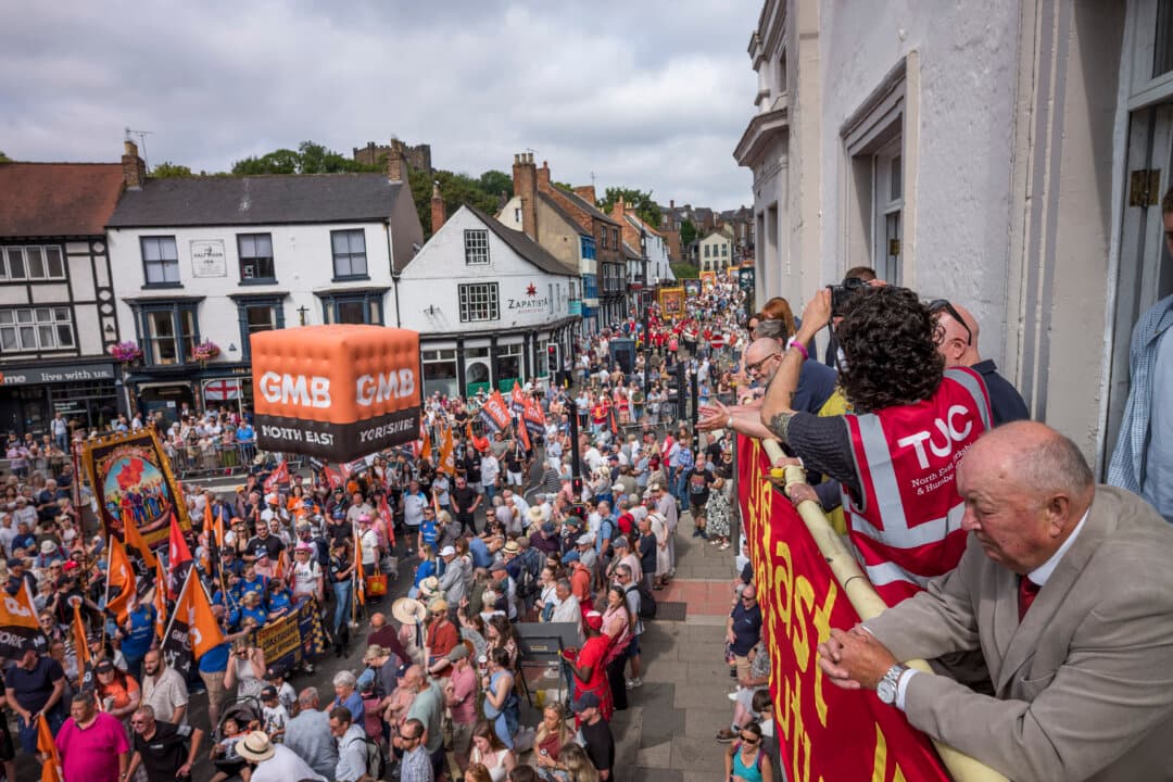 Colliery banners are carried and bands play as they march through Durham during the 140th Durham Miners’ Gala in Durham, England, on July 11, 2026. Known locally as “The Big Meeting,” the event has been hosted by the Durham Miners’ Association since 1871. (Ian Forsyth/Getty Images)