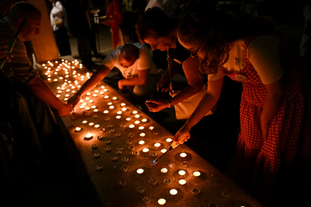 People light candles in Pristina, Kosovo, on July 11, 2026, marking the 31st anniversary of the 1995 Srebrenica genocide. (Armend Nimani/AFP via Getty Images)