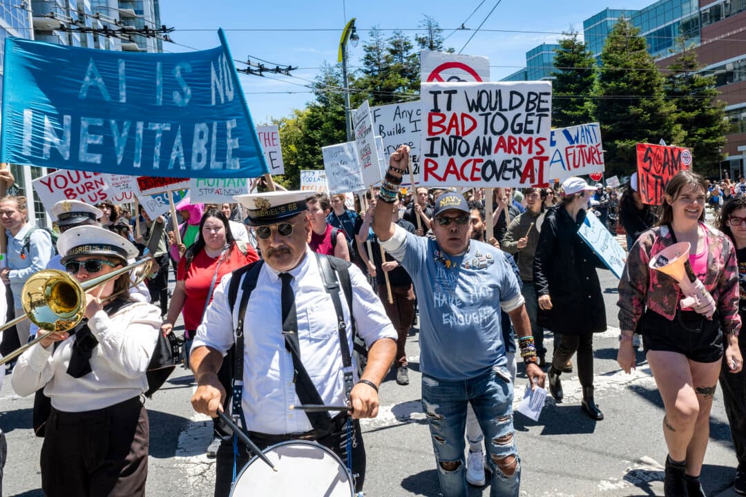 Members of St. Gabriel's Celestial Brass Band march alongside demonstrators during the “Stop the AI Race” protest march in San Francisco on July 11, 2026. The protestors are making stops outside the offices of OpenAI, Anthropic, and Google DeepMind. (Karl Mondon/AFP via Getty Images)