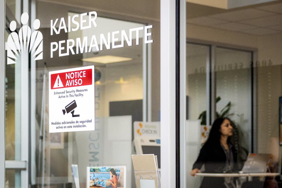 A Kaiser Permanente employee works at a Kaiser Permanente Medical Office in Manhattan Beach, Calif., on July 19, 2024. Kaiser allegedly pushed doctors to add diagnoses to patient charts, according to the Department of Justice. (Etienne Laurent/AFP via Getty Images)