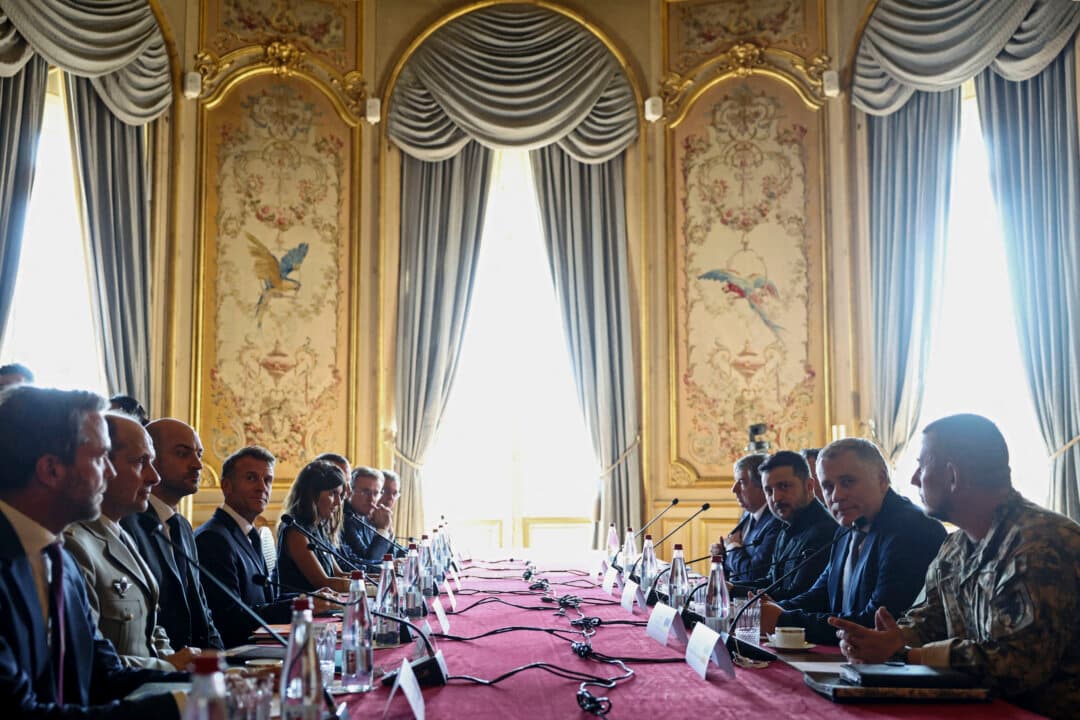 Ukraine's President Volodymyr Zelenskyy (center R) and France's President Emmanuel Macron (center L) take part in the Integrated Anti-Ballistic Missile Coalition meeting ahead of a summit of the Coalition of the Willing to support Ukraine at the Hotel des Invalides in Paris on July 13, 2026. (Tom Nicholson/POOL/AFP via Getty Images)
