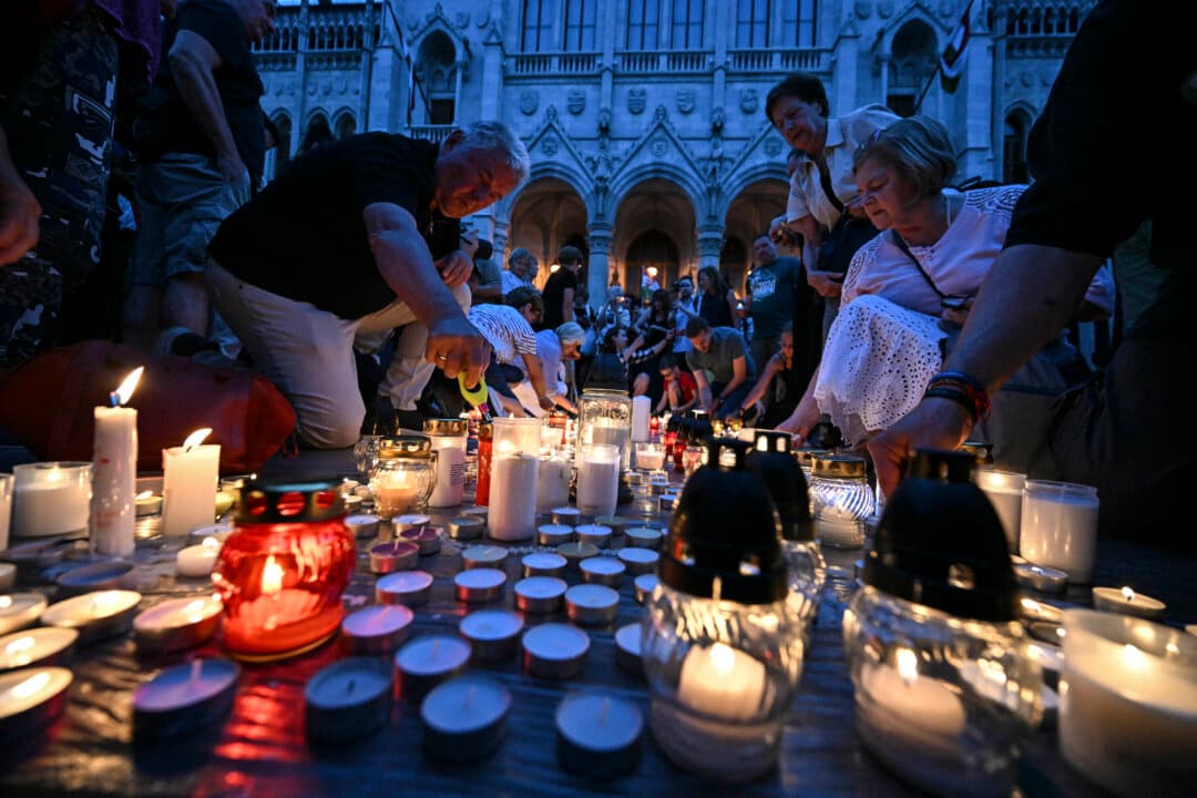 Supporters of the former ruling party, FIDESZ, protest the amendment to the Fundamental Law with a candlelight at Kossuth Lajos Square, in front of the parliament building in Budapest, Hungary, on July 13, 2026. (Attila Kisbenedek/AFP via Getty Images)