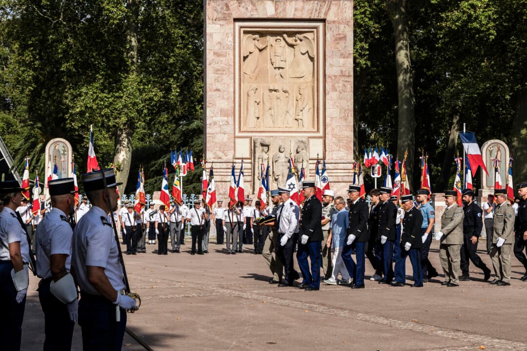 A march of future recipients of the Republic's decorations in front of flag bearers and the war memorial in Perpignan, France, on July 13, 2026. On the eve of Bastille Day, Perpignan's National Rally mayor, Louis Aliot, organized his July 14 military parade. (Jc Milhet/Hans Lucas/AFP via Getty Images)