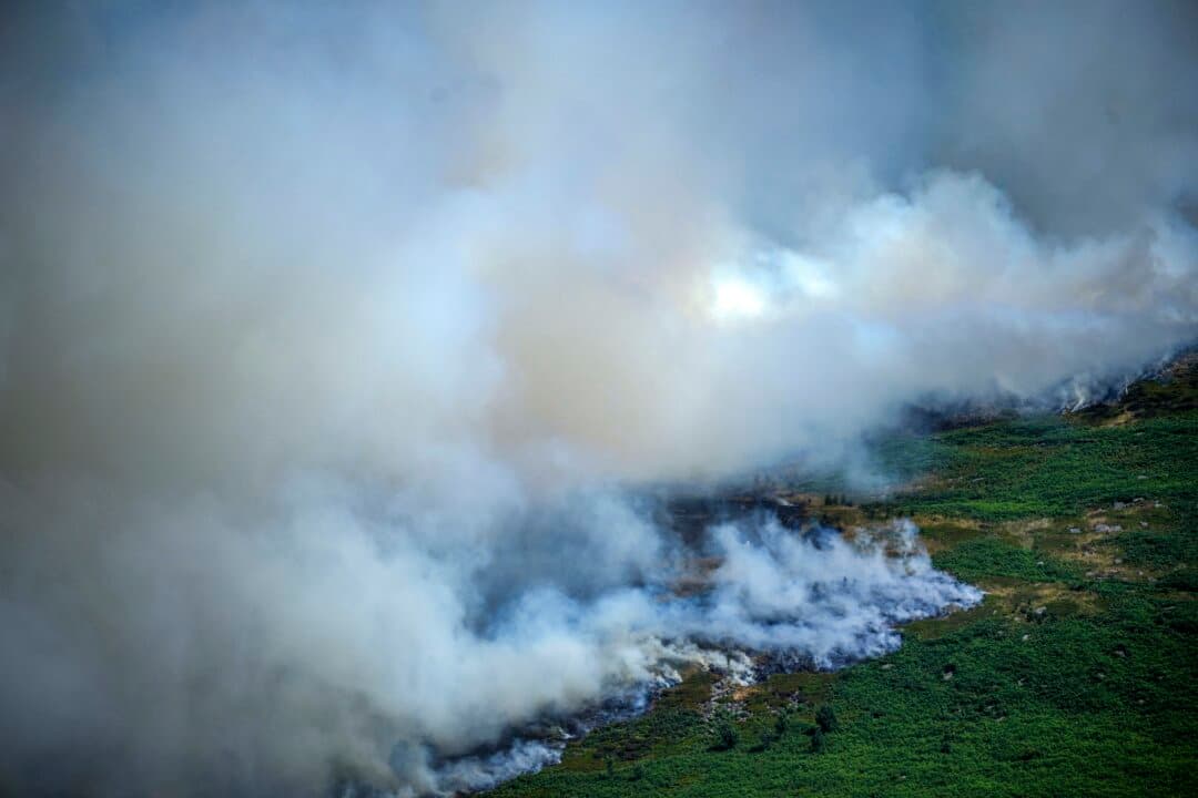 Smoke rises from a wildfire near Glossop, England, on July 13, 2026. A major incident has been declared between Glossop, Derbyshire, and Dovecote Reservoir, Greater Manchester, as high winds and a severe heatwave have caused a wildfire, which originally broke out on June 24, to flare up. (Christopher Furlong/Getty Images)