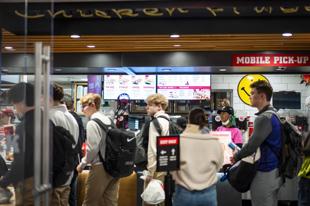 Customers wait at Raising Canes Chicken Fingers in Washington on March 12, 2026. In 2025, Americans spent around 55 percent of their food dollars on items prepared outside the home at restaurants, fast-food chains, and through takeout delivery services. (Madalina Kilroy/The Epoch Times)