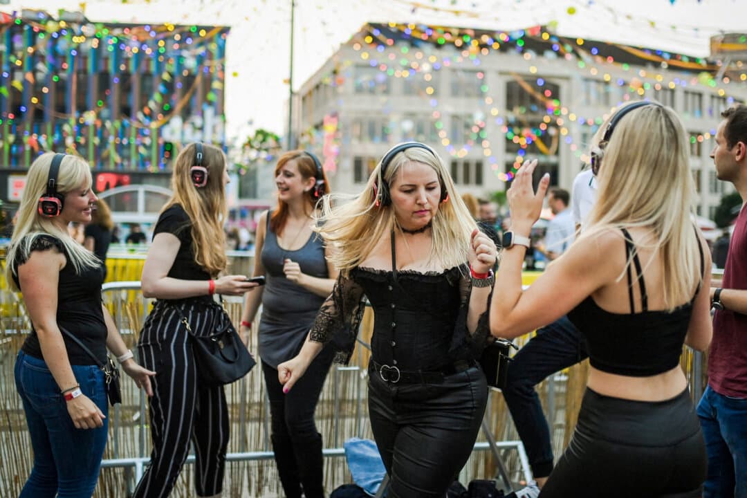 Participants tune in to multiple channels using their wireless headphones during a “Headphone Disco” event at the Kennedyplatz plaza in Essen, Germany, on July 9, 2021. A surge in digital content offers numerous choices for today's music lovers. (Ina Fassbender / AFP via Getty Images)