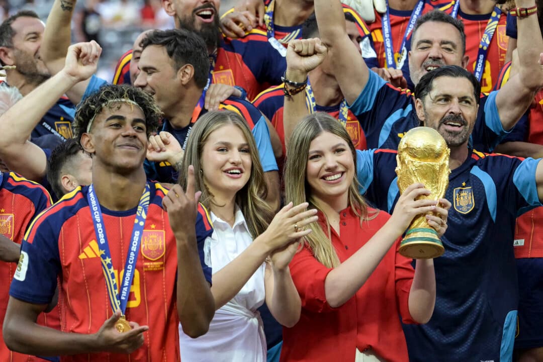 Spain's Princess Sofia (R) lifts the trophy surrounded by Spain's forward #19 Lamine Yamal (L) and Princess Leonor after Spain's football players won the 2026 World Cup football tournament final match between Spain and Argentina at the New York New Jersey Stadium in East Rutherford, N.J., on July 19, 2026. (Juan Mabromata/AFP via Getty Images)