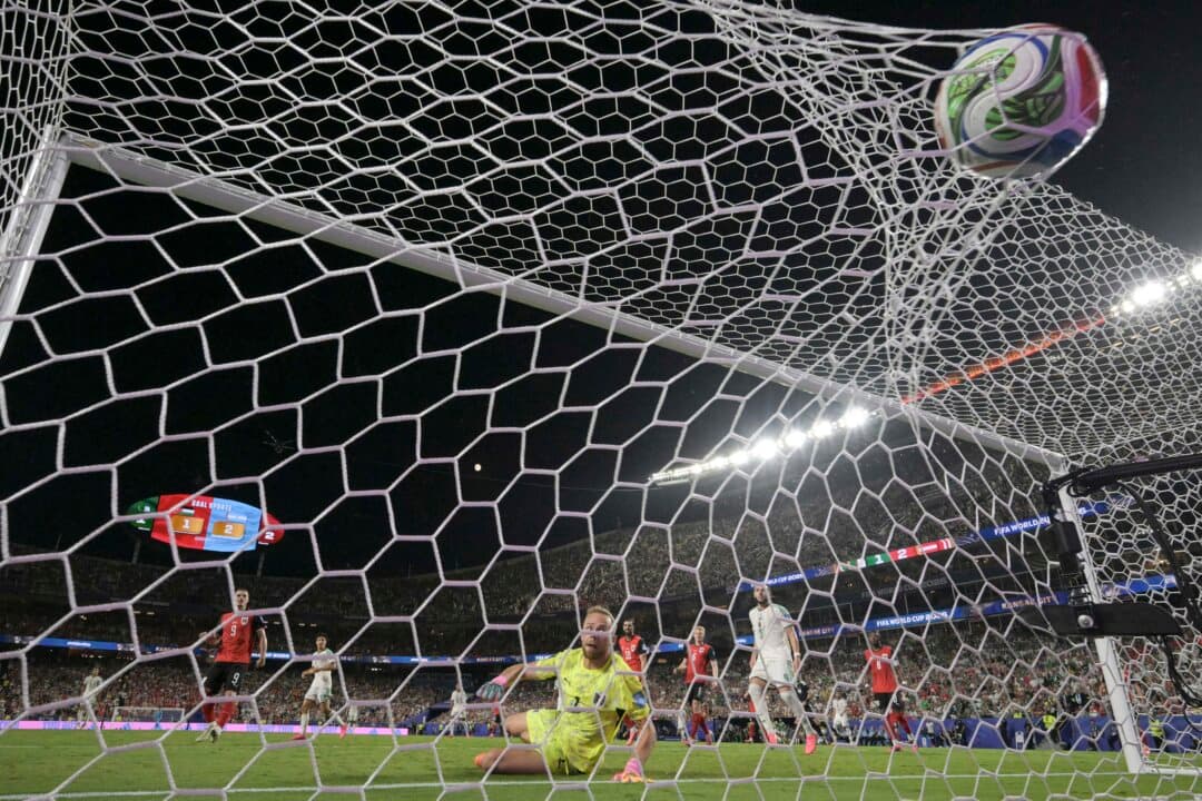 Austria's goalkeeper #1 Alexander Schlager looks at the ball after failing to stop a goal by Algeria's forward #7 Riyad Mahrez during the 2026 World Cup Group J football match between Algeria and Austria at the Kansas City Stadium in Kansas City, Mo., on June 27, 2026. (Juan Mabromata/AFP via Getty Images)