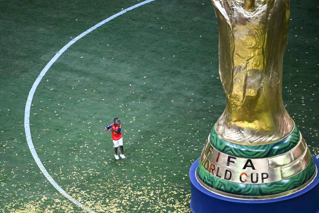 Keyne, brother of Spain's forward #19 Lamine Yamal, gestures next to a giant replica of the trophy following the trophy ceremony after Spain won the 2026 World Cup football tournament final match between Spain and Argentina at the New York New Jersey Stadium in East Rutherford, N.J., on July 19, 2026. (Mauro Pimentel/AFP via Getty Images)