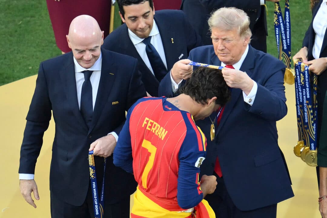 Spain's forward #7 Ferran Torres (front) receives the gold medal from FIFA President Gianni Infantino (L) and President Donald Trump (R) during the final ceremony after the 2026 World Cup football tournament final match between Spain and Argentina at the New York New Jersey Stadium in East Rutherford, N.J., on July 19, 2026. (Angela Weiss/AFP via Getty Images)