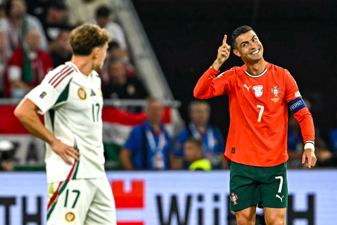 Portugal's forward #7 Cristiano Ronaldo (R) celebrates after scoring the 1–2 penalty goal as Hungary's midfielder #17 Callum Styles reacts during the 2026 World Cup qualifiers Europe zone group F football match between Hungary and Portugal in Budapest, Hungary, on Sept. 9, 2025. (Attila Kisbenedek/AFP via Getty Images)