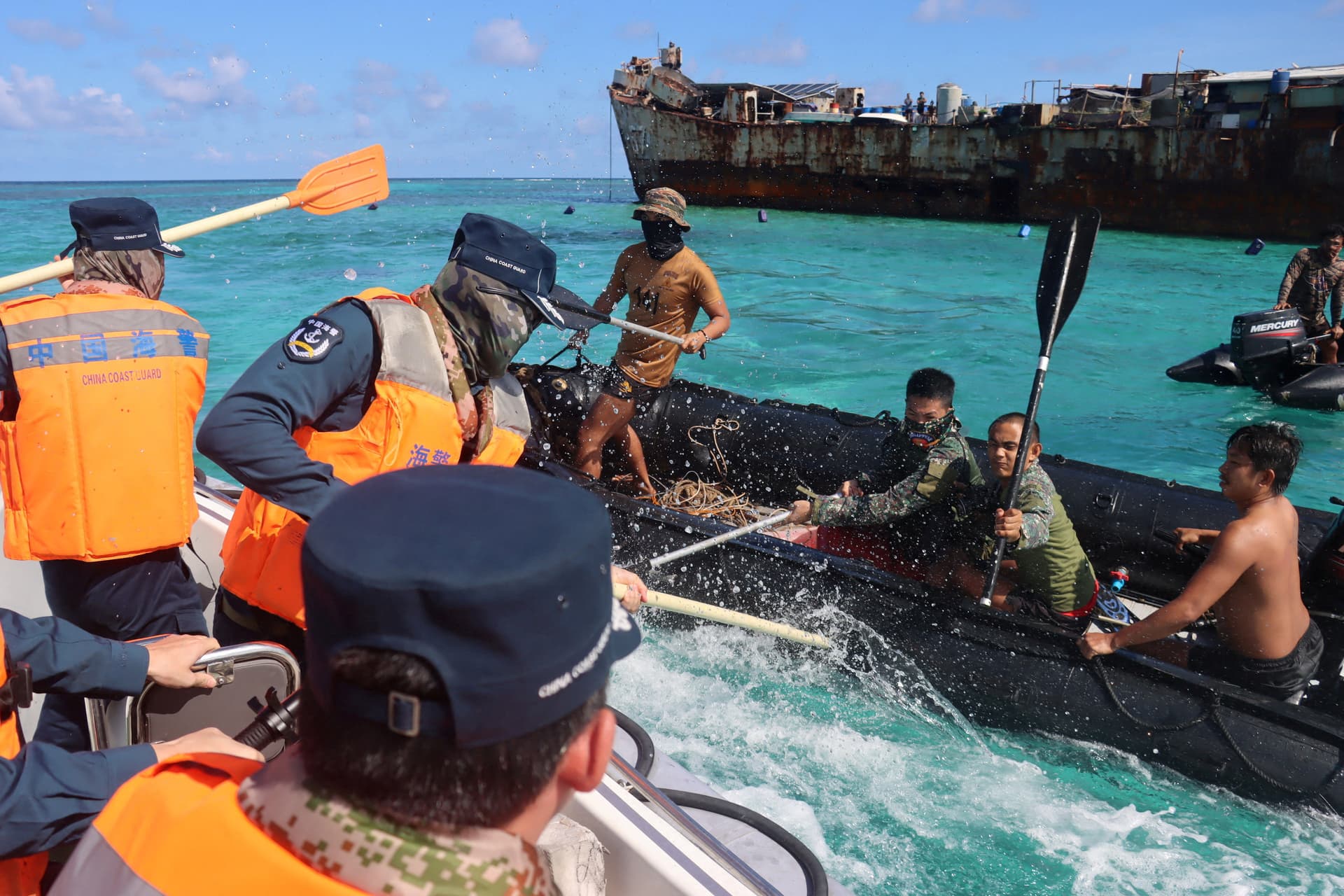 China Coast Guard personnel (L) and Philippine Navy personnel (R) clash near a grounded Philippine warship at Second Thomas Shoal, in the South China Sea, on July 20, 2026. (cnsphoto via Reuters)
