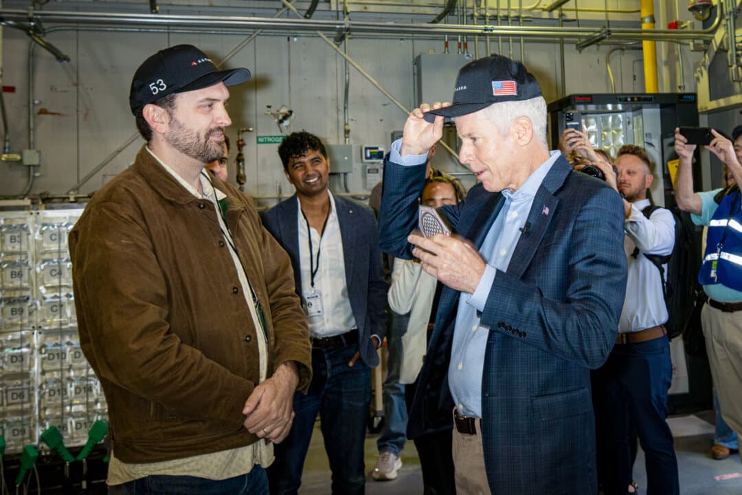 Secretary of Energy Chris Wright (R) receives swag from Jordan Bramble (L), CEO and co-founder of Antares, at Idaho National Laboratory west of Idaho Falls, Idaho, on June 25, 2026. Wright visited the laboratory to celebrate recent advancements in nuclear energy, particularly with small modular reactors and microreactors. (Natalie Behring/Getty Images)