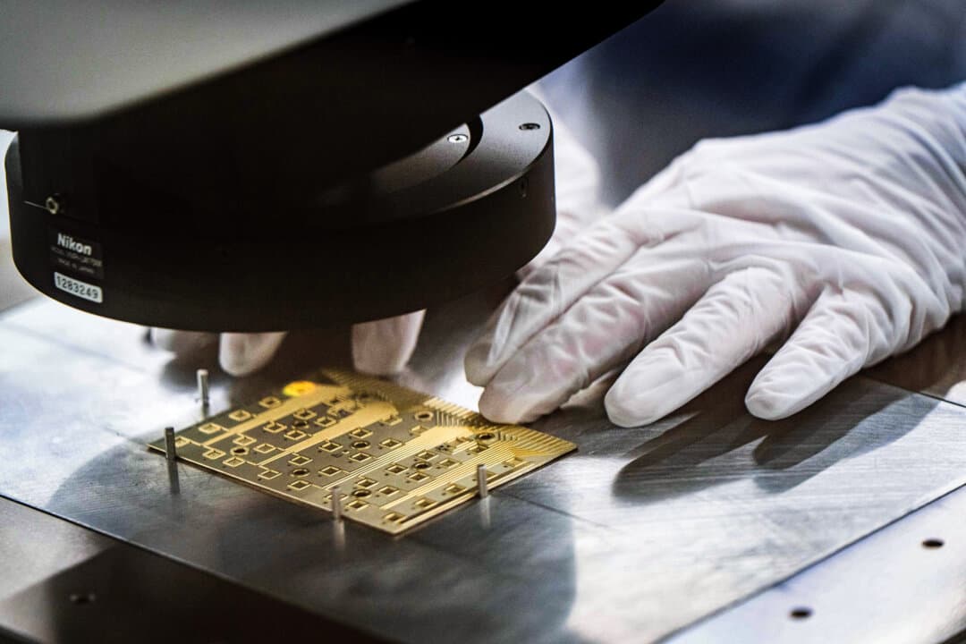 A worker conducts testing in a Coherent manufacturing facility where lasers are developed for transmitting data among chips, which could decrease power use by AI systems, in Sherman, Texas, on June 16, 2026. Data centers are switching to light, transitioning from copper to fiber optics as AI systems grow. (Jeffrey McWhorter/AP Photo)