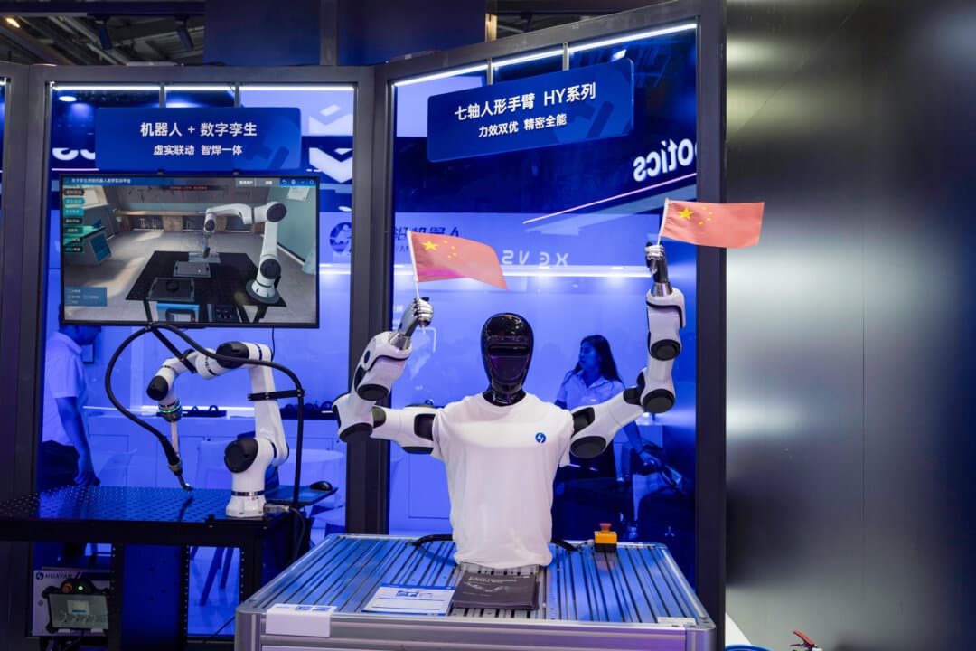 A humanoid robot from Chinese firm Huayan Robotics waves Chinese national flags during the World AI Conference in Shanghai on July 18, 2026. (Ng Han Guan/AP Photo)