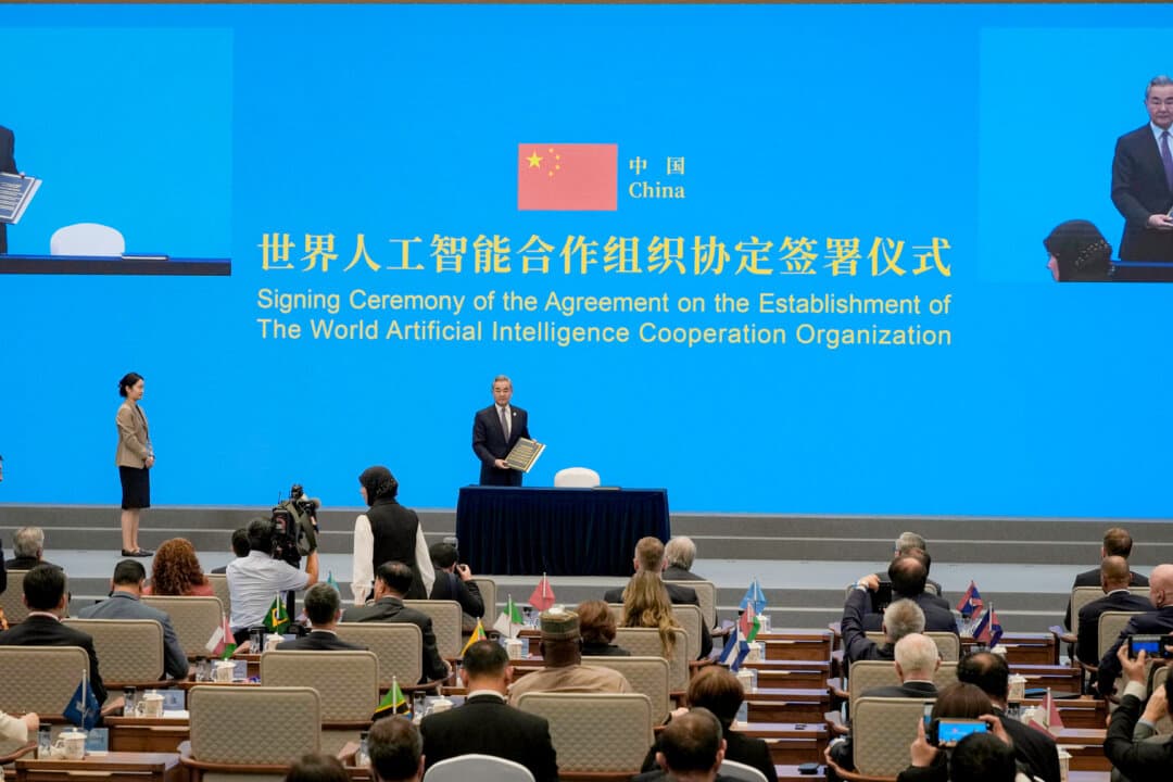 Chinese foreign minister Wang Yi and representatives of 29 countries at the signing of the agreement on the establishment of the World Artificial Intelligence Cooperation Organization ahead of the World AI Conference in Shanghai on July 16, 2026. The real divide in the AI competition is moral, says a former People's Liberation Army engineer. (Ng Han Guan-Pool/Getty Images)