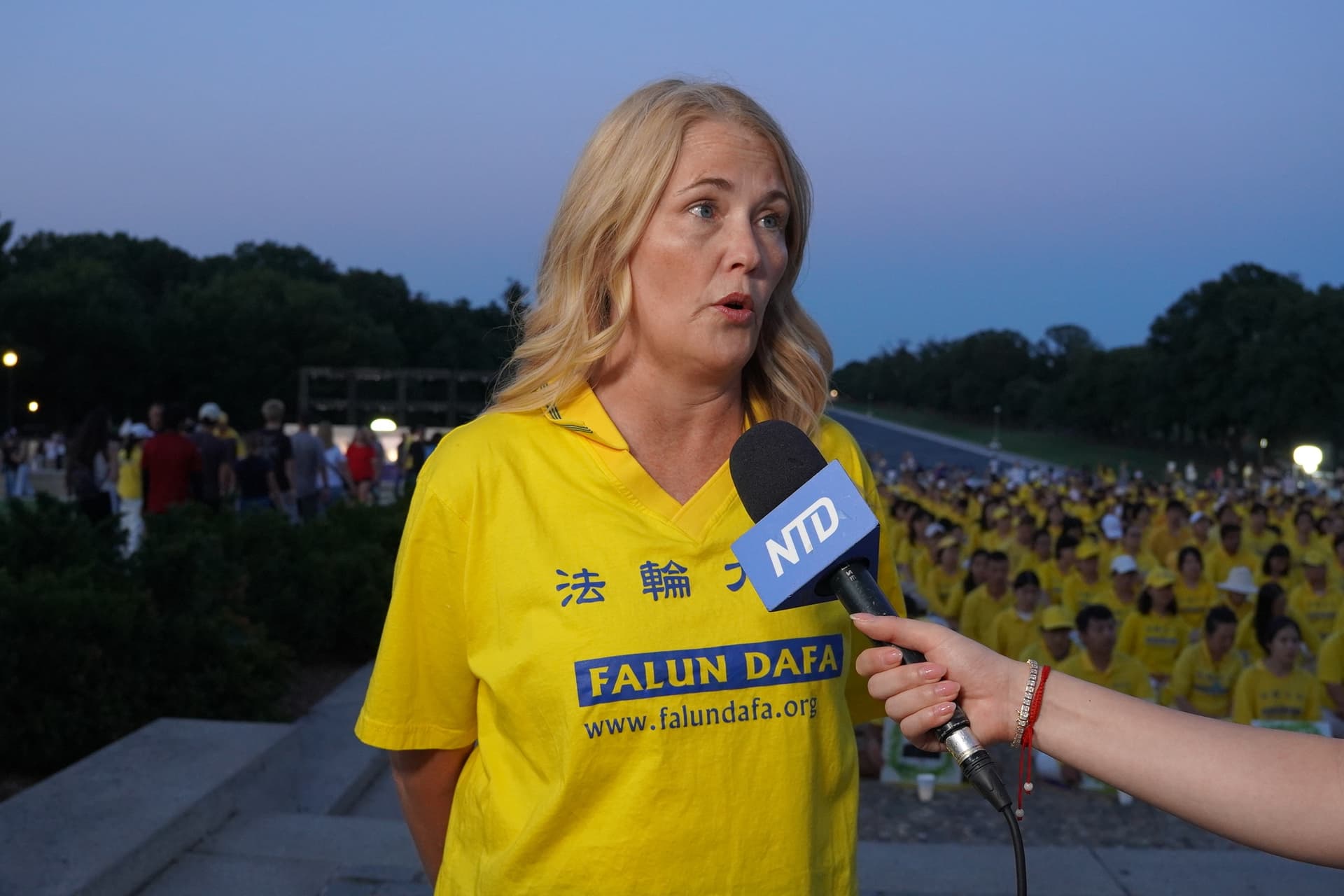 Mary Manthey, a Falun Gong practitioner from Michigan, speaks to reporters during a candlelight vigil at the Lincoln Memorial in Washington on July 23, 2026. (Terri Wu/The Epoch Times)