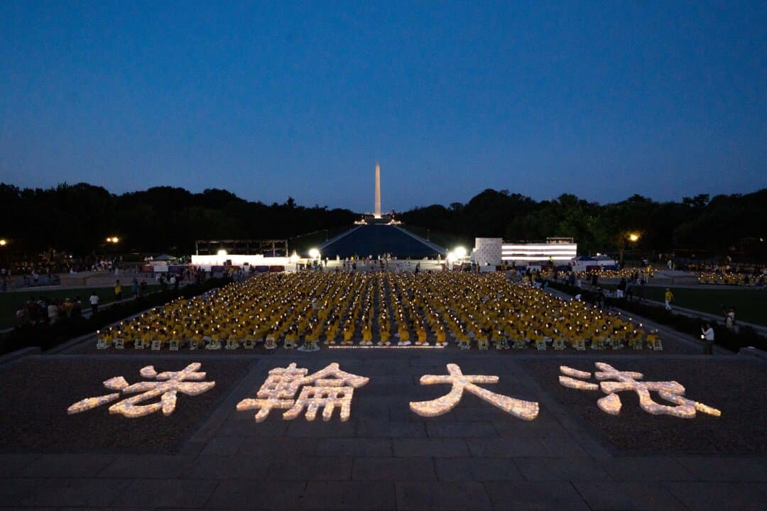 Falun Dafa practitioners hold candles at the Lincoln Memorial in Washington on July 23, 2026. (Samira Bouaou/The Epoch Times)