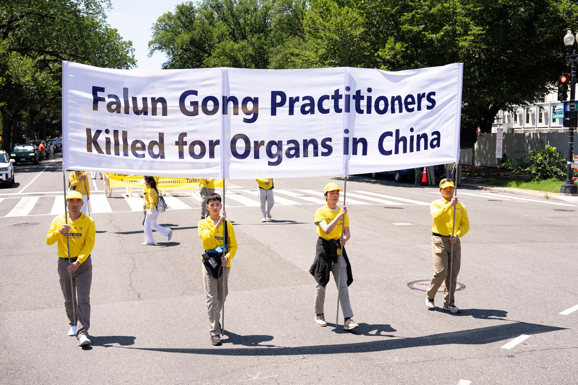 Falun Dafa practitioners take part in a march calling for the end of the Chinese Communist Party’s 27 years of persecution of Falun Gong in China, in Washington on July 23, 2026. (Larry Dye/The Epoch Times)