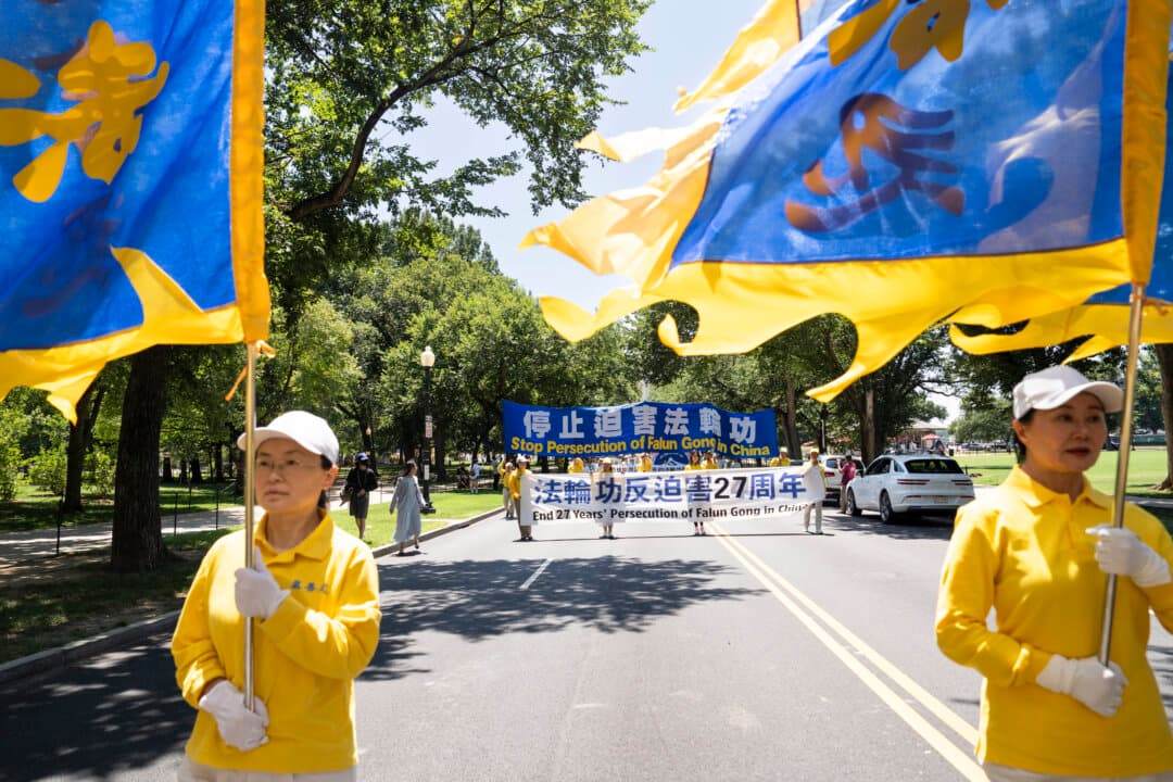 Falun Dafa practitioners march in Washington on July 23, 2026. (Madalina Kilroy/The Epoch Times)