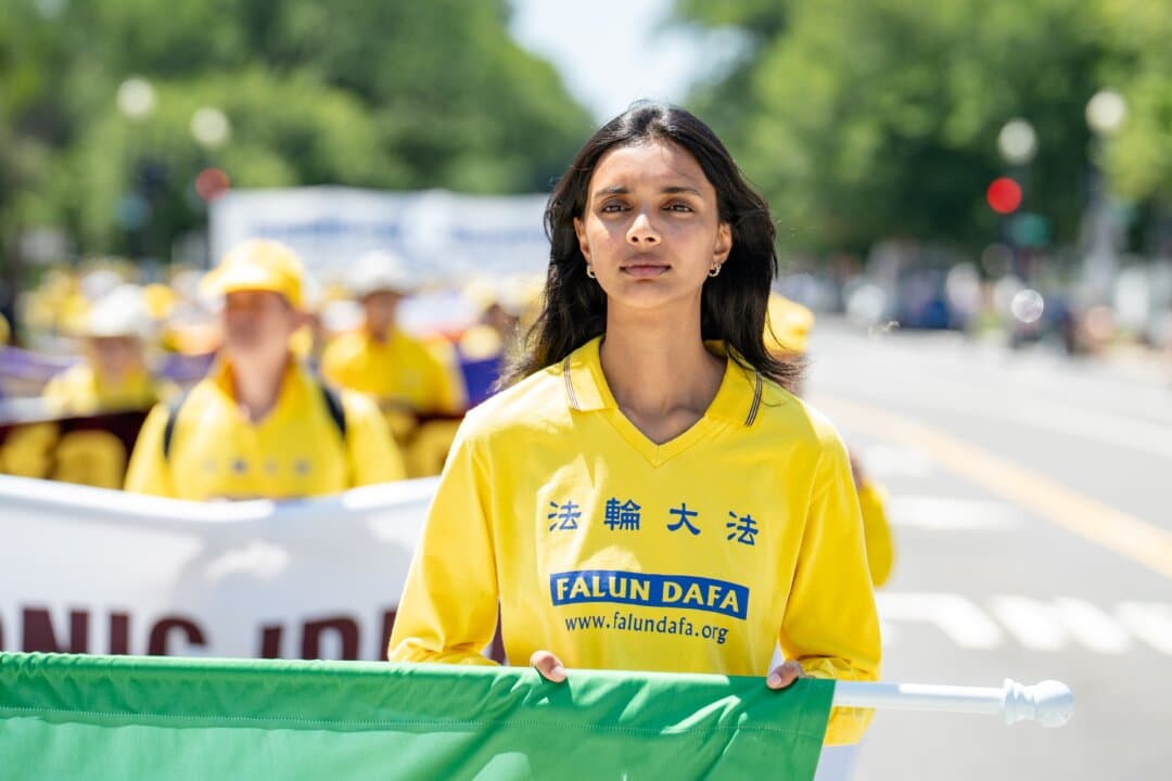 A Falun Dafa practitioner marches in Washington July 23, 2026. (Samira Bouaou/The Epoch Times)