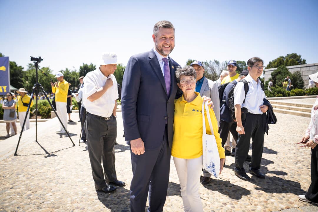 Rep. Pat Ryan (D-N.Y.) meets with Falun Dafa practitioners during the annual rally at the Lincoln Memorial in Washington on July 23, 2026. (Madalina Kilroy/The Epoch Times)