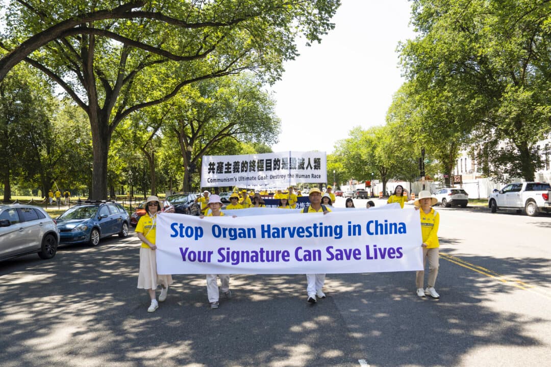 Falun Dafa practitioners raise awareness about Chinese Communist Party’s forced organ harvesting from practitioners in China, in Washington on July 23, 2026. (Madalina Kilroy/The Epoch Times)