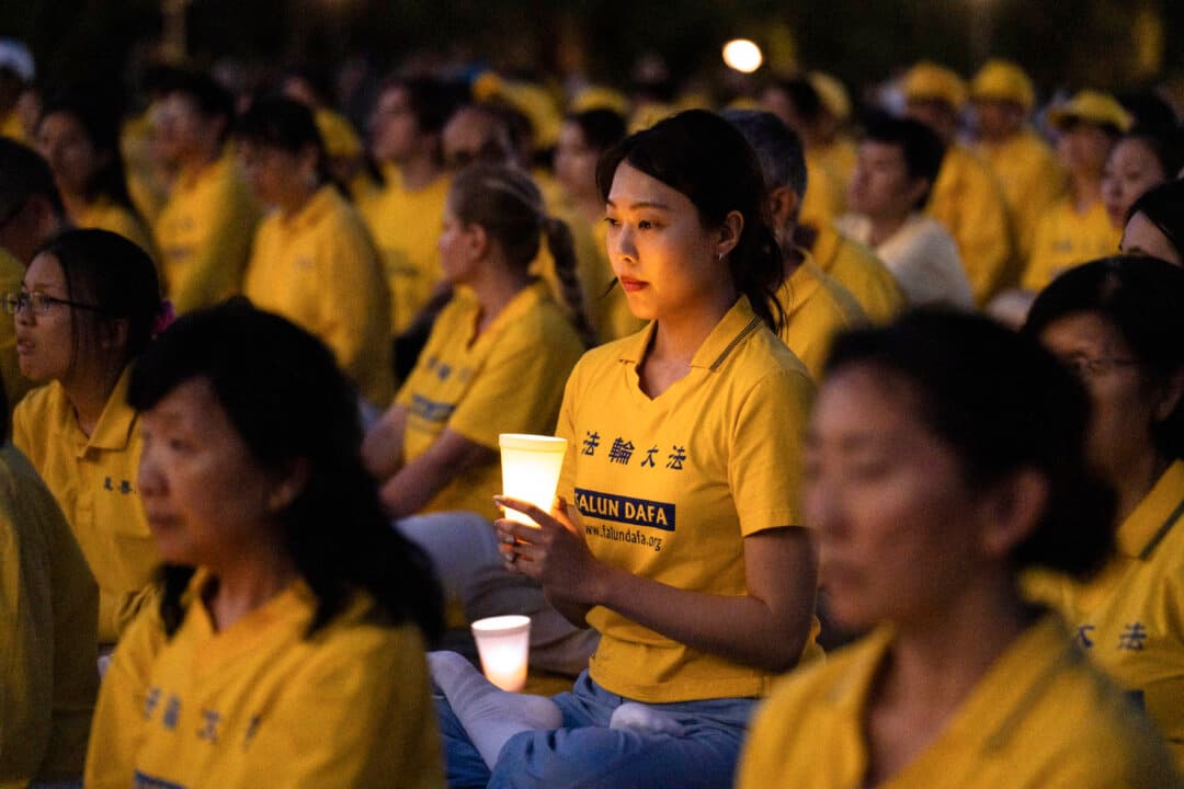 Falun Dafa practitioners during a candlelight vigil commemorating fellow practitioners who were persecuted to death by the Chinese Communist Party in China, at the Lincoln Memorial in Washington on July 23, 2025. (Samira Bouaou/The Epoch Times)