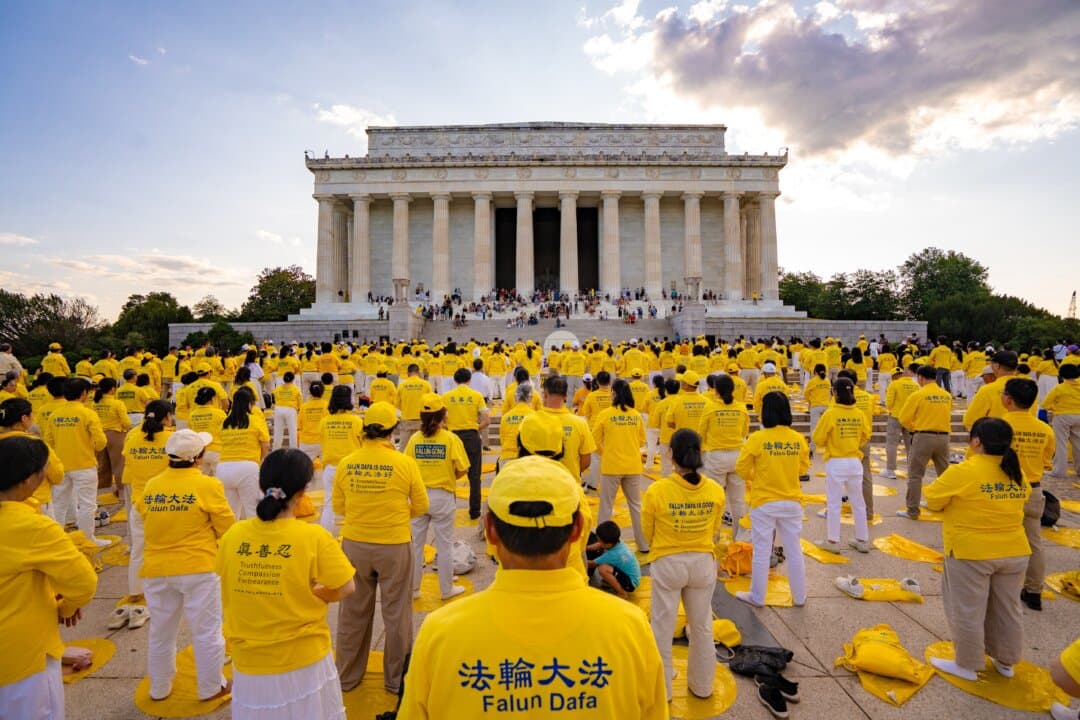 Falun Dafa practitioners practice the exercises ahead of the candlelight vigil on July 23, 2026. (Samira Bouaou/The Epoch Times)