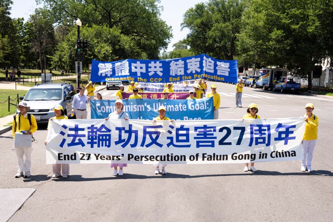 Falun Dafa practitioners take part in a march calling for the end of the Chinese Communist Party’s 27 years of persecution of Falun Gong in China, in Washington on July 23, 2026. (Larry Dye/The Epoch Times)