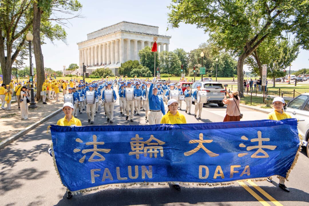 Falun Dafa practitioners take part in a march calling for the end of the Chinese Communist Party’s 27 years of persecution of Falun Gong in China, in Washington on July 23, 2026. (Samira Bouaou/The Epoch Times)