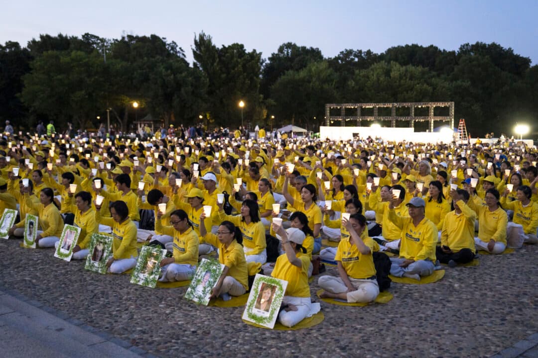 Falun Dafa practitioners during a candlelight vigil at the Lincoln Memorial in Washington on July 23, 2026. (Madalina Kilroy/The Epoch Times)