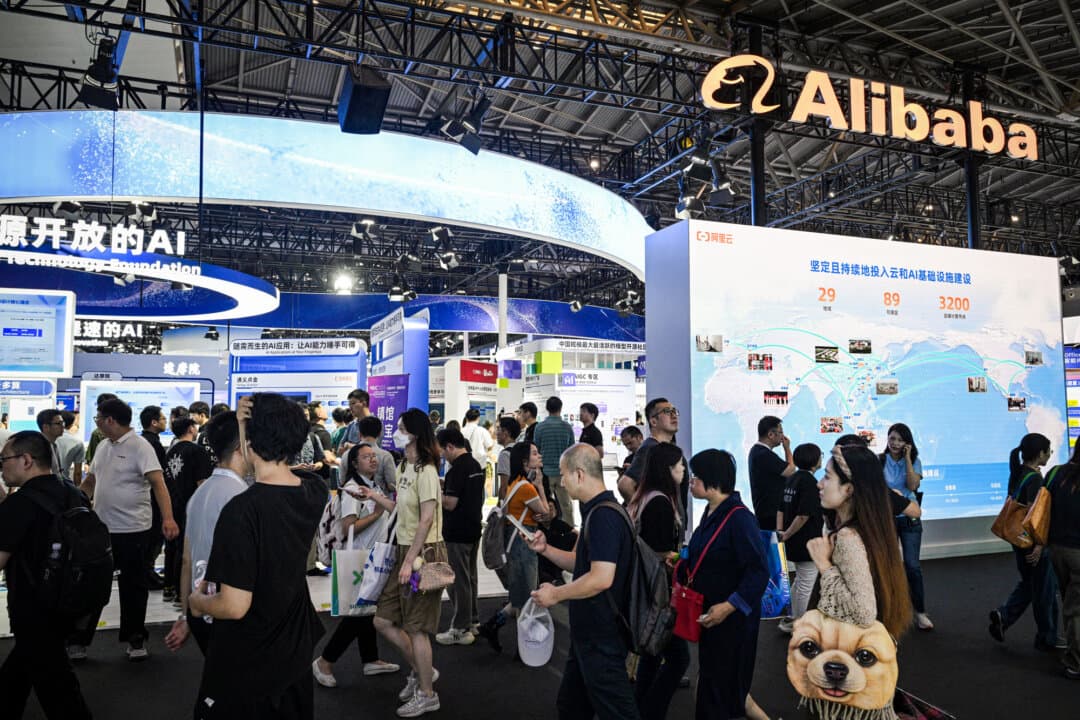 People pass the Alibaba stand during the World Artificial Intelligence Conference at the Shanghai World Expo Exhibition and Convention Center in Shanghai on July 28, 2025. The commercial giant announced that it would contest its designation on the Pentagon's expanded 1260H list. (Hector Retamal/AFP via Getty Images)