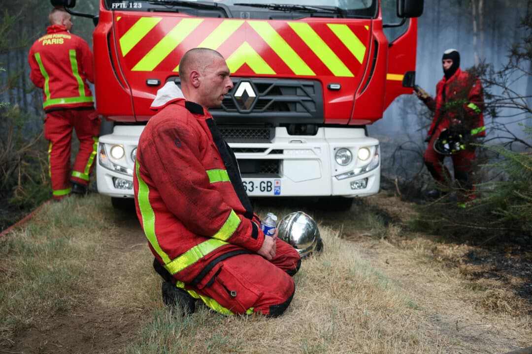 Firefighters of Paris Fire Brigade rest in Marcheprime west of Bordeaux, France, on July 26, 2026. A wildfire has been ravaging the forest north of the Arcachon Basin (Gironde) since July 22. The fire that has engulfed the area around the Arcachon Basin and is now threatening the outskirts of the Bordeaux metropolitan area has destroyed 42,000 hectares, the Gironde prefecture announced. The prefecture has evacuated a total of 220,000 people since July 22. (Alain Jocard/AFP via Getty Images)