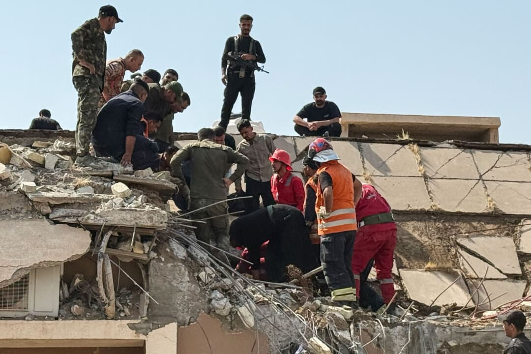 Security forces and emergency personnel work at the site of U.S.–Saudi strikes that targeted a base belonging to Iraq's Hashed al-Shaabi Forces north of al-Miqdadiyah district in Diyala province, Iraq, on July 29, 2026. The strikes killed at least 20 members of a former paramilitary alliance that includes pro-Iran groups, according to the alliance. (Younis Al-Bayati/AFP via Getty Images)