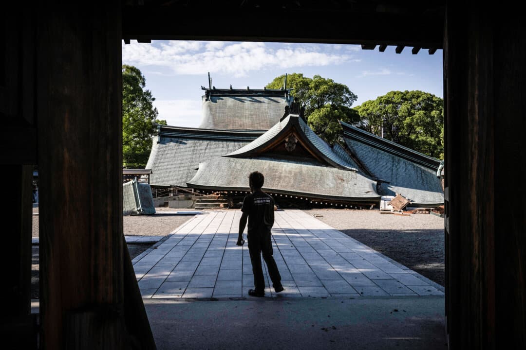 A man visits the collapsed Yatsushiro Shrine after an earthquake struck the previous day, in Yatsushiro, Japan, on July 29, 2026. (Yuichi Yamazaki/AFP via Getty Images)